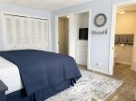 Main level primary bedroom has a king bed, Smart TV, sitting area, and ensuite bathroom